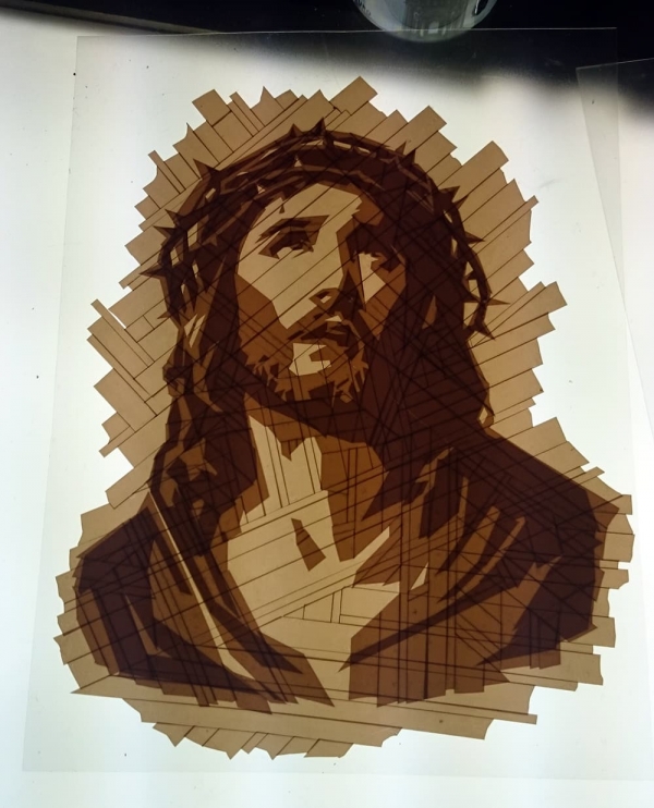 The emergence of tape art Jesus portrait from package tape