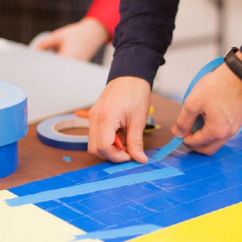 Workshop Participant Hands and Tape Rolls