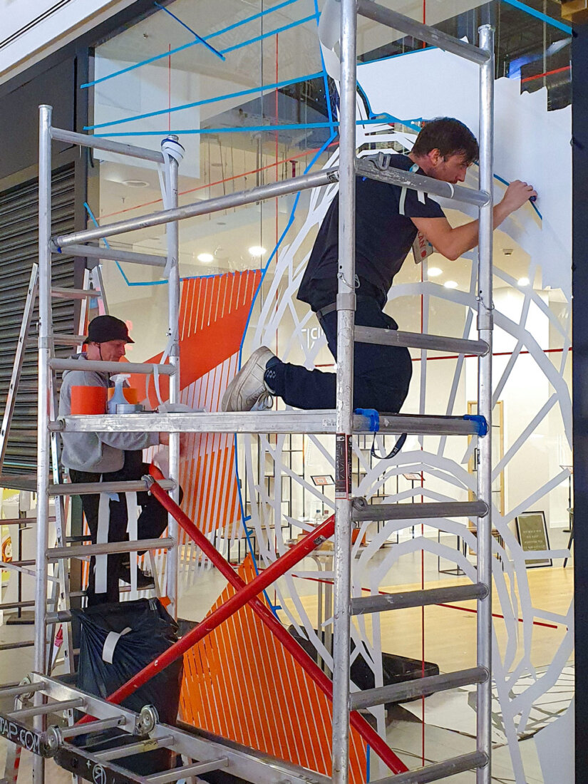 Crew at work on a tape art pop-up store activation