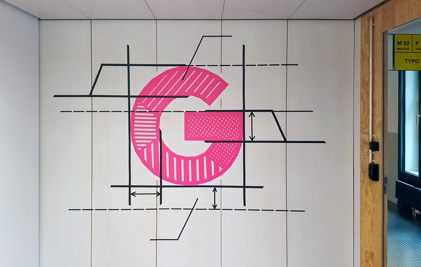 Typographic tape art mural in a Google office in Zurich